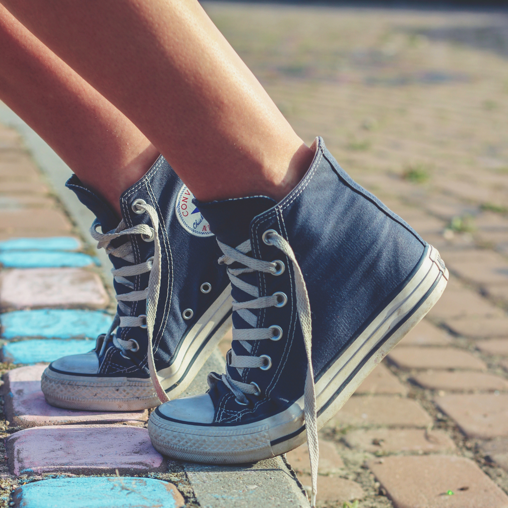 Pair of red Converse shoes with white laces and rubber soles