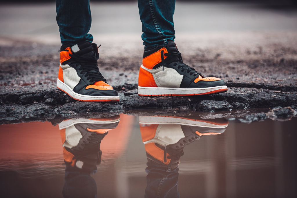 Image of a person's designer shoes being cleaned by our service. Our professional cleaning process will keep your shoes looking fresh and new for longer